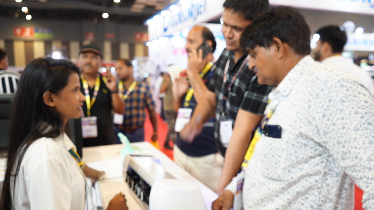 Visitors talking with the Skycut team at the expo booth.