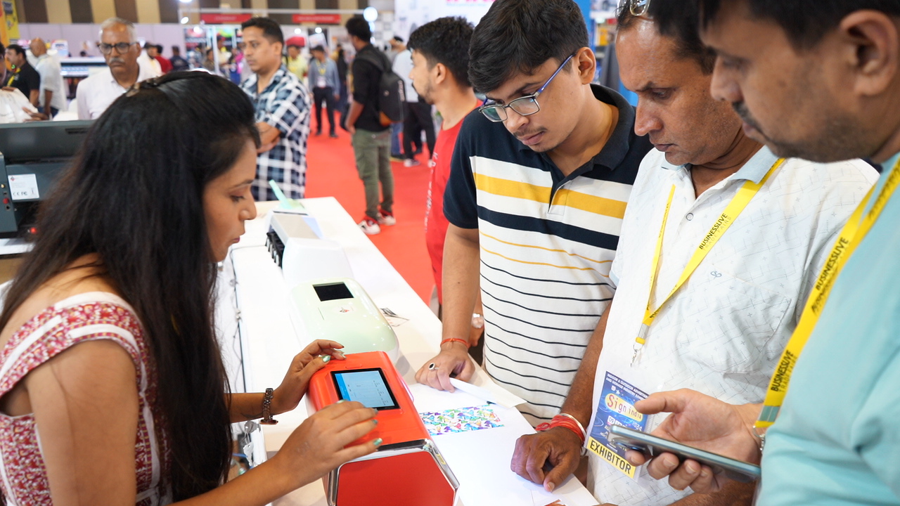 A Skycut exhibitor showing a machine at the expo.