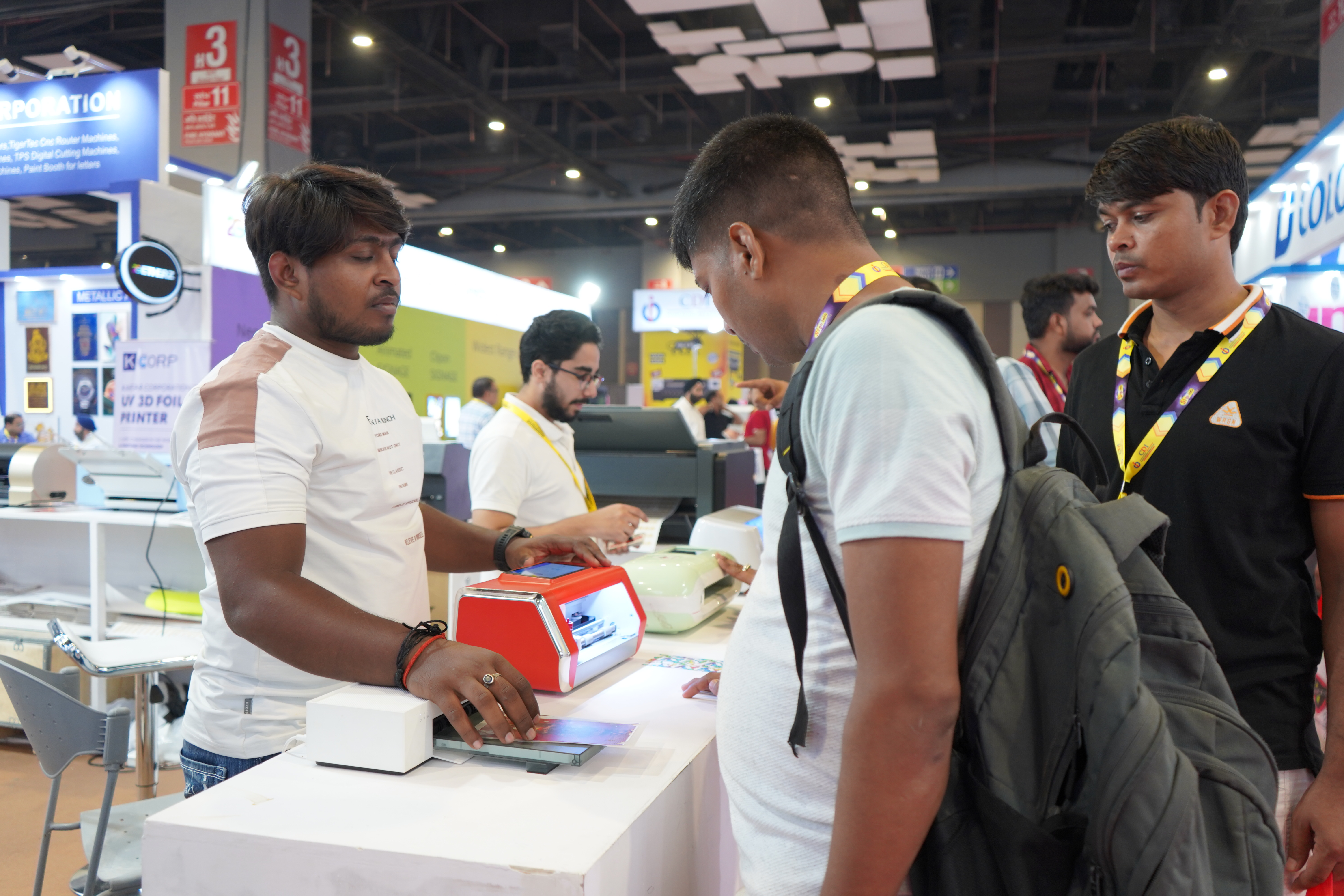 A visitor watching a Skycut machine cut at the expo.